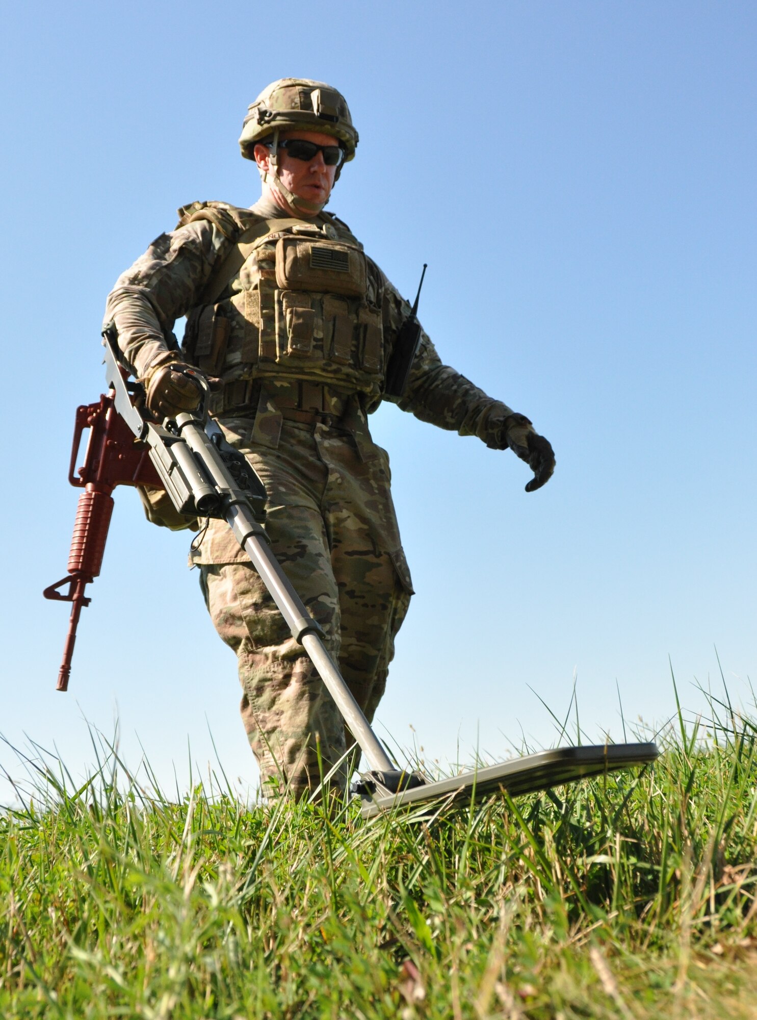 Staff Sgt. John Nelson, a 512th Explosive Ordnance Disposal Flight EOD technician, operates a compact metal detector to locate a simulated weapons cache placed by mock enemy combatants in a staged forward operating area Aug. 1, 2015, at Dover Air Force Base, Del. Five EOD technicians participated in the conventional weapons disposal training exercise. (U.S. Air Force photo/Staff Sgt. Joe Yanik)