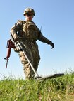 Staff Sgt. John Nelson, a 512th Explosive Ordnance Disposal Flight EOD technician, operates a compact metal detector to locate a simulated weapons cache placed by mock enemy combatants in a staged forward operating area Aug. 1, 2015, at Dover Air Force Base, Del. Five EOD technicians participated in the conventional weapons disposal training exercise. (U.S. Air Force photo/Staff Sgt. Joe Yanik)
