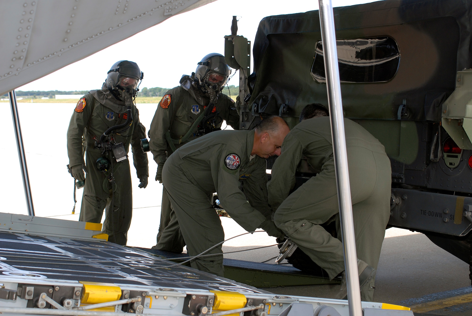 Loadmasters with the 169th Airlift Squadron attach a Humvee to a winch down aboard a C-130 Hercules during training at the 182nd Airlift Wing, Peoria, Ill., Aug. 1, 2015. The training was conducted to ensure that the loadmasters are always on mission and ready for real-world scenarios. (U.S. Air National Guard photo by Tech. Sgt. Dawn Rademake/Released)