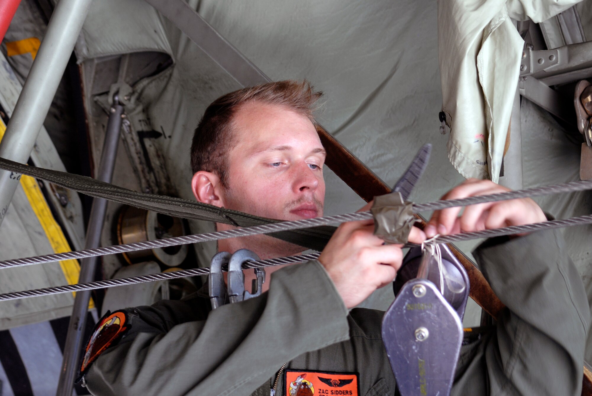 U.S. Air Force Senior Airman Zachary A. Sidders, a loadmaster with the 169th Airlift Squadron, performs maintenance during training at the 182nd Airlift Wing, Peoria, Ill., Aug. 1, 2015. The training was conducted to ensure that the loadmasters are always on mission and ready for real-world scenarios. (U.S. Air National Guard photo by Tech. Sgt. Dawn Rademaker/Released)