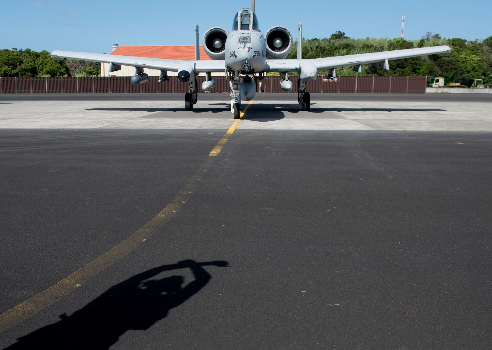 Captain Rachael Winiecki, a 354th Expeditionary Fighter Squadron A-10 Thunderbolt II pilot, is marshalled in by Senior Airman Samuel Clark, a 65th Operations Support Squadron transient alert maintenance technician, on Lajes Field, Azores, Portugal, August 1, 2015. The 354th Expeditionary Fighter Squadron returns home after deploying 12 A-10s as part of a Theater Security Package in support of Operation Atlantic Resolve, to Spangdahlem AB, Germany where they conducted training alongside our NATO allies to strengthen interoperability and to demonstrate U.S. commitment to the security and stability of Europe. (U.S. Air Force photo by Master Sgt. Bradley C. Church).
