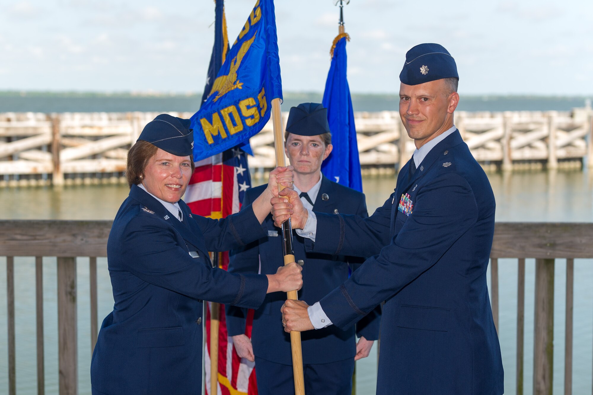 Col. Julie Stola, 45th Space Wing Medical Group commander, presents Lt. Col. William Breedlove, with the 45th MDSS guidon during a change of command ceremony June 15, 2015, at Patrick Air Force Base, Fla. Changes of command are a military tradition representing the transfer of responsibilities from the presiding officials to the upcoming official. (U.S. Air Force photo/Cory Long) (Released)