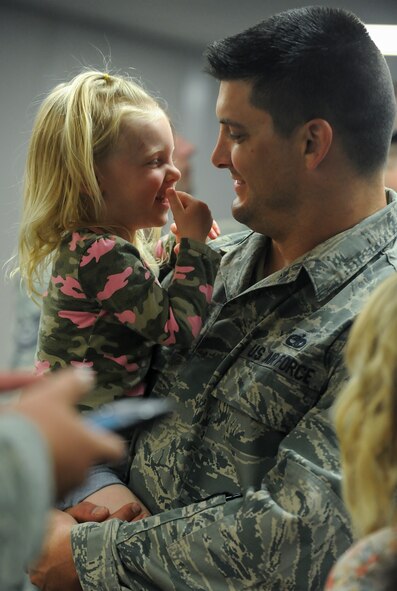 Staff Sgt. David Wagner, 5th Maintenance Squadron metals technologist, holds his youngest daughter Aleana at Minot Air Force Base, N.D., Aug. 1, 2015. Wagner returned from spending approximately three weeks at Nellis Air Force Base, Nev., where he participated in Red Flag 15-3 training. (U.S. Air Force photo/Senior Airman Stephanie Morris)