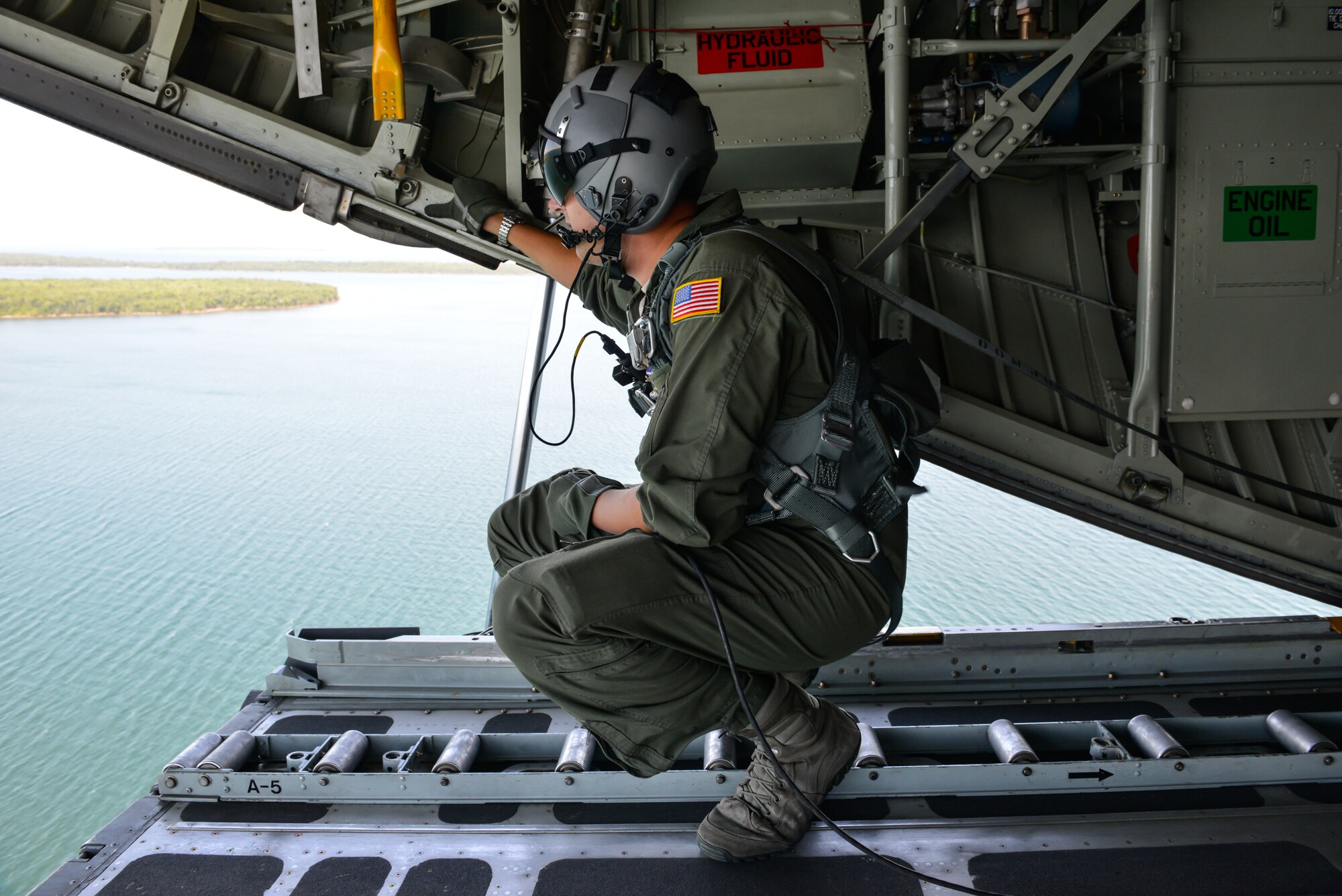 Loadmaster Staff Sgt. Brian Beckmann, 96th Airlift Squadron, looks out the back of a C-130 during a flight for the Employers of 934th Airlift Wing Airmen. Employers are invited out to the August training assembly weekend for the annual Employer's Day event at the Minneapolis-St. Paul Air Reserve Station, Minn. (U.S. Air Force photo by Staff Sgt. Corban Lundborg/Released)