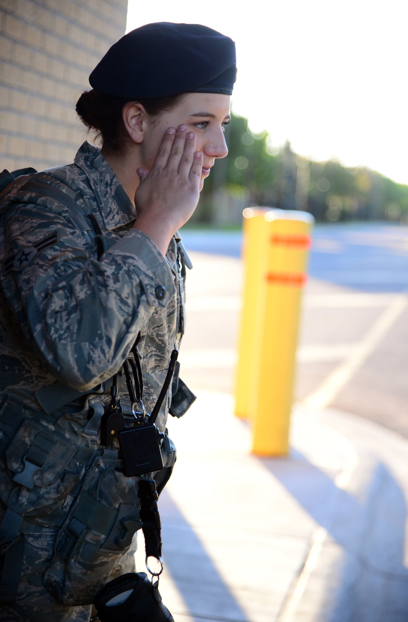 Airman 1st Class Heidi Curfman, 341st Security Forces Squadron defender, pays proper customs and courtesies by saluting an officer July 31, 2015, at Malmstrom Air Force Base, Mont. Curfman is required to conduct a 100 percent vehicle occupancy ID check while Department of Defense facilities are in Force Protection Condition Bravo. (U.S. Air Force photo/Airman 1st Class Magen M. Reeves)