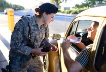 Airman 1st Class Heidi Curfman, 341st Security Forces Squadron defender, checks an ID at the front gate July 31, 2015, at Malmstrom Air Force Base, Mont. Curfman conducts a 100 percent vehicle occupancy ID check at the gate before allowing entry onto the base. (U.S. Air Force photo/Airman 1st Class Magen M. Reeves)