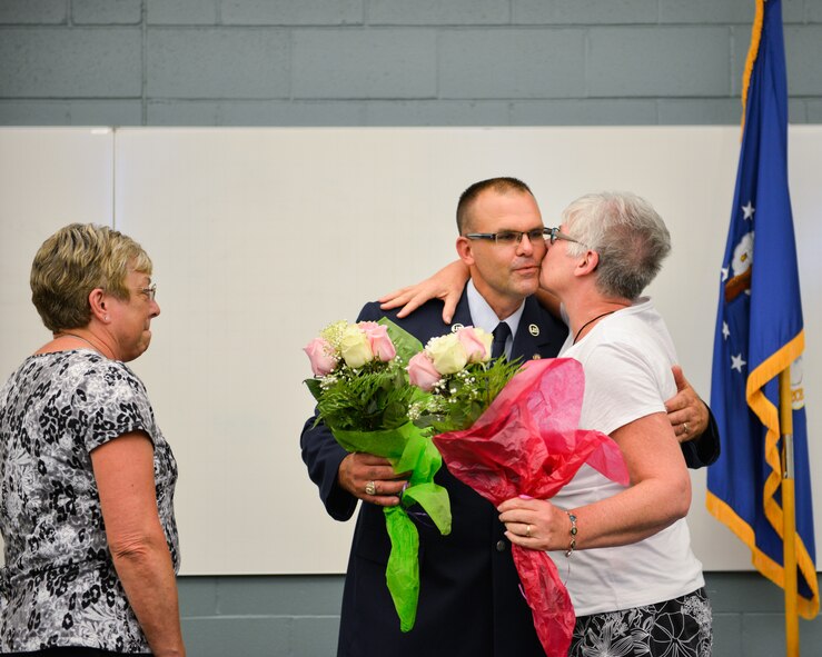 Tech. Sgt. Marc Small, 934th Logistics Readiness Squadron, embraces his mother during his retirement ceremony at the Minneapolis-St. Paul Air Reserve Station, Minn. Sergeant Small served over 25 years in the military and as a training manager provided combat ready Airmen. (U.S. Air Force photo by Staff Sgt. Corban Lundborg/Released)