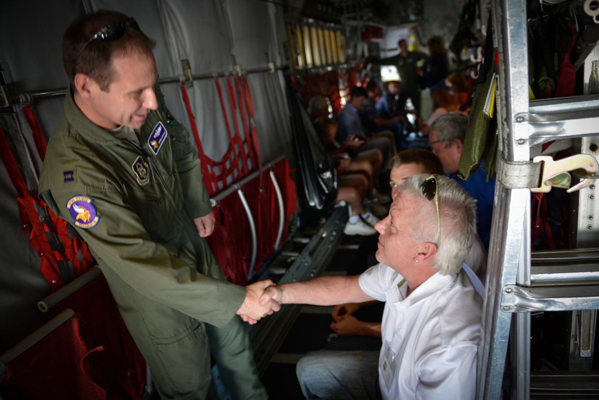 Capt. Andrew Reinhardt, 96th Airlift Squadron, greets Bruce Selvig, employer of reservist Chief Master Sgt. Orin Johnson, also in the 96 AS. Employers of 934th Airlift Wing Airmen were invited to the August training assembly weekend for the annual Employer's Day at the Minneapolis-St. Paul Air Reserve Station, Minn. (U.S. Air Force photo by Staff Sgt. Corban Lundborg/Released)