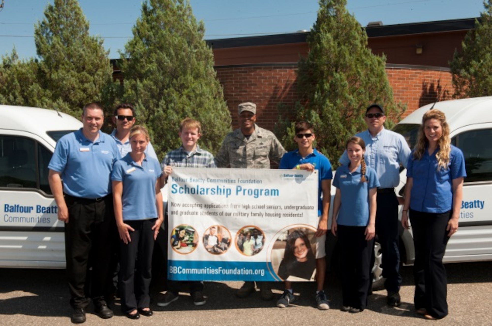 Col. Roy Collins, 5th Mission Support Group commander, and recipients of the Balfour Beatty Communities Foundation Academic Scholarship pose with members of Balfour Beatty at Minot Air Force Base, N.D., July 24, 2015. BBC awarded 52 academic scholarships for the 2015-2016 year. (U.S. Air Force photo/Airman 1st Class Christian Sullivan)