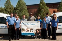 Col. Roy Collins, 5th Mission Support Group commander, and recipients of the Balfour Beatty Communities Foundation Academic Scholarship pose with members of Balfour Beatty at Minot Air Force Base, N.D., July 24, 2015. BBC awarded 52 academic scholarships for the 2015-2016 year. (U.S. Air Force photo/Airman 1st Class Christian Sullivan)