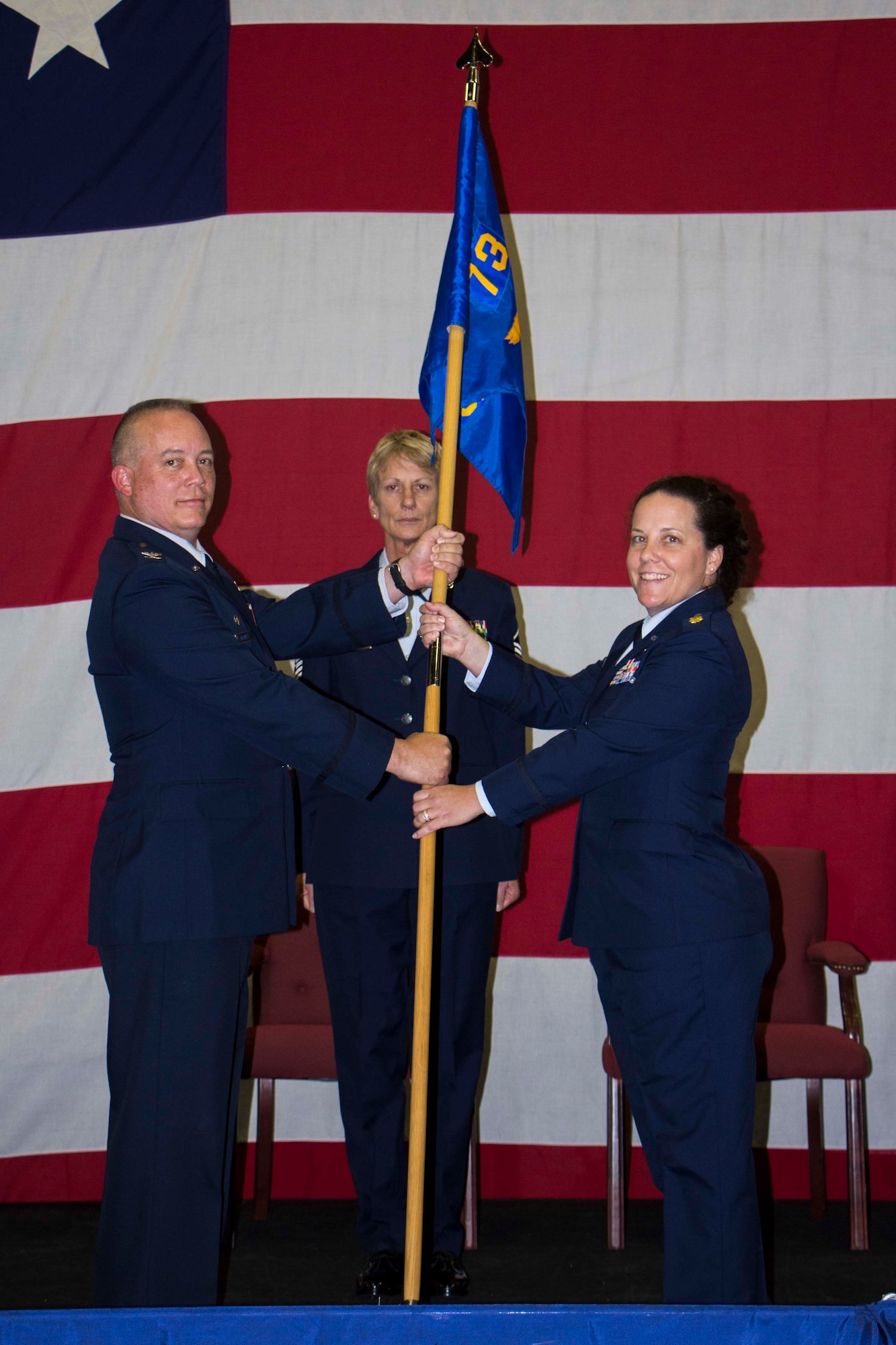 NAVAL AIR STATION FORT WORTH JOINT RESERVE BASE, Texas - New 73rd Aerial Port Squadron Commander Maj. Gloria Awe receives her squadron’s guidon Aug. 1 in a change of command ceremony here. Presiding over the ceremony was 301st Mission Support Group Commander Col. Jeffery Barnett.  Awe is teacher in her civilian job in addition to serving as traditional reservist in the Air Force Reserve. (U.S. Air Force photo/Senior Airman Ben Calantas)