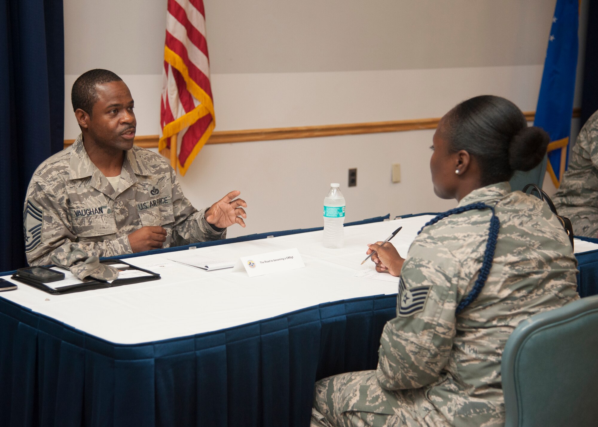 Chief Master Sgt. Naim Vaughan, 436th Civil Engineer Squadron superintendent, talks with Tech. Sgt. Zina Dromov, 373d Training Squadron military training leader, during the Top III’s Speed Mentoring event, July 29, 2015, at The Landings Club on Dover Air Force Base, Del. Vaughan told Dromov about what steps to take to become a Chief. (U.S. Air Force photo/Senior Airman Jared Duhon) 