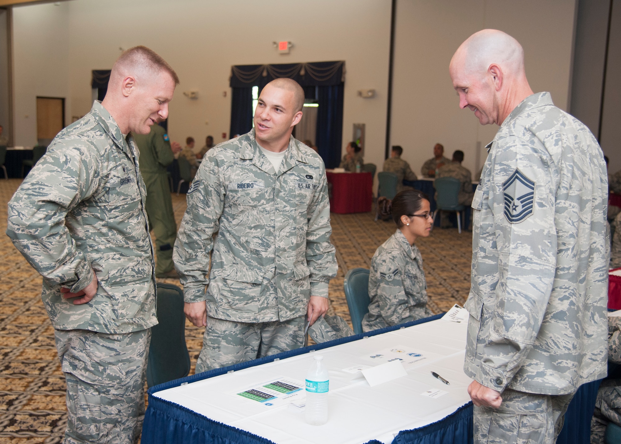 Col. Michael W. Grismer, 436th Airlift Wing commander, speaks with Staff Sgt. Eliezer Ribeiro, 436th Logistics Readiness Squadron quality assurance inspector, and Senior Master Sgt. Steven Dirksen, 9th Airlift Squadron loadmaster superintendent, during the Top III’s Speed Mentoring event, July 29, 2015, at The Landings Club on Dover Air Force Base, Del. The Top III held the Speed Mentoring session to give Airmen an opportunity to talk with Senior NCOs about different career focus areas. (U.S. Air Force photo/Senior Airman Jared Duhon)  
