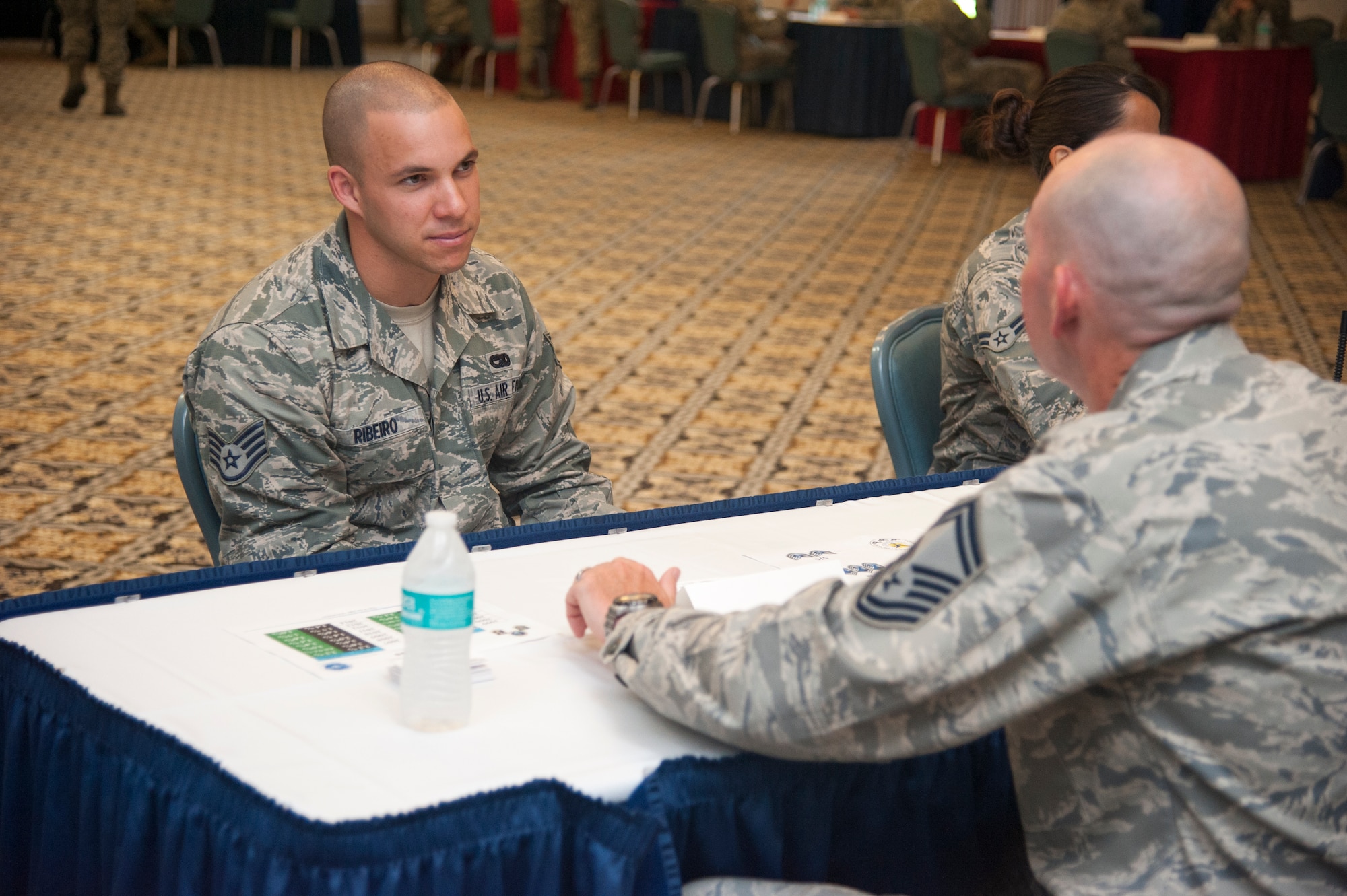 Staff Sgt. Eliezer Ribeiro, 436th Logistics Readiness Squadron quality assurance inspector, talks with Senior Master Sgt. Steven Dirksen, 9th Airlift Squadron loadmaster superintendent, during the Top III’s Speed Mentoring event, July 29, 2015, at The Landings Club on Dover Air Force Base, Del.  Dirksen spoke about how participation in professional organizations can benefit an Airman’s career. (U.S. Air Force photo/Senior Airman Jared Duhon) 