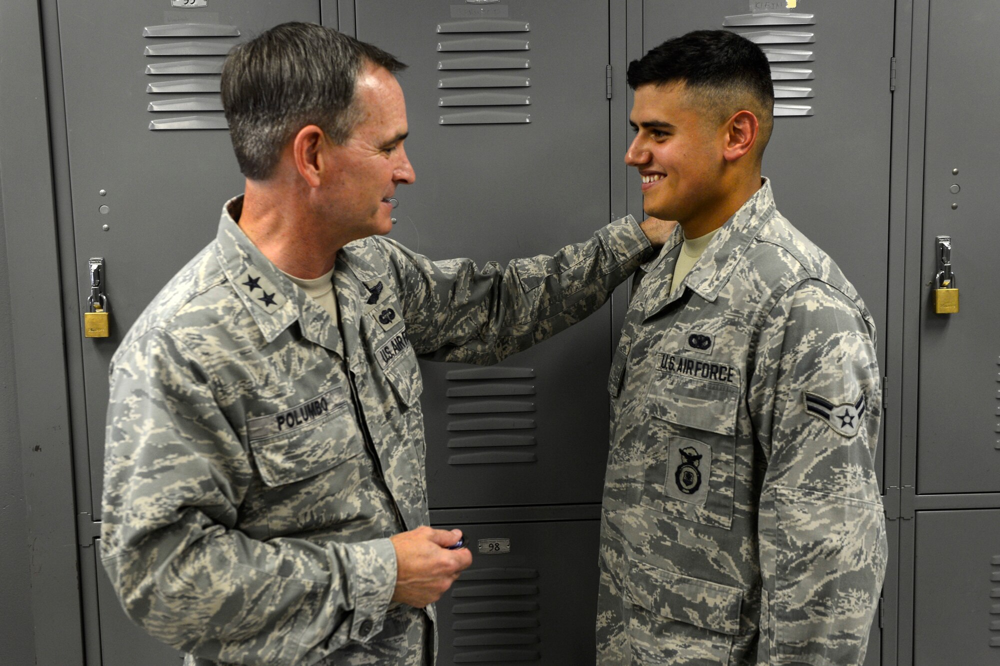 U.S. Air Force Maj. Gen. H. D. Polumbo Jr., Ninth Air Force commander, recognizes Airman 1st Class Daniel Ortiz, 20th Security Forces Squadron installation entry controller, at Shaw Air Force Base, S.C., July 28, 2015. Polumbo coined Ortiz for his hard work and constant positive attitude. (U.S. Air Force photo by Senior Airman Jensen Stidham/Released)