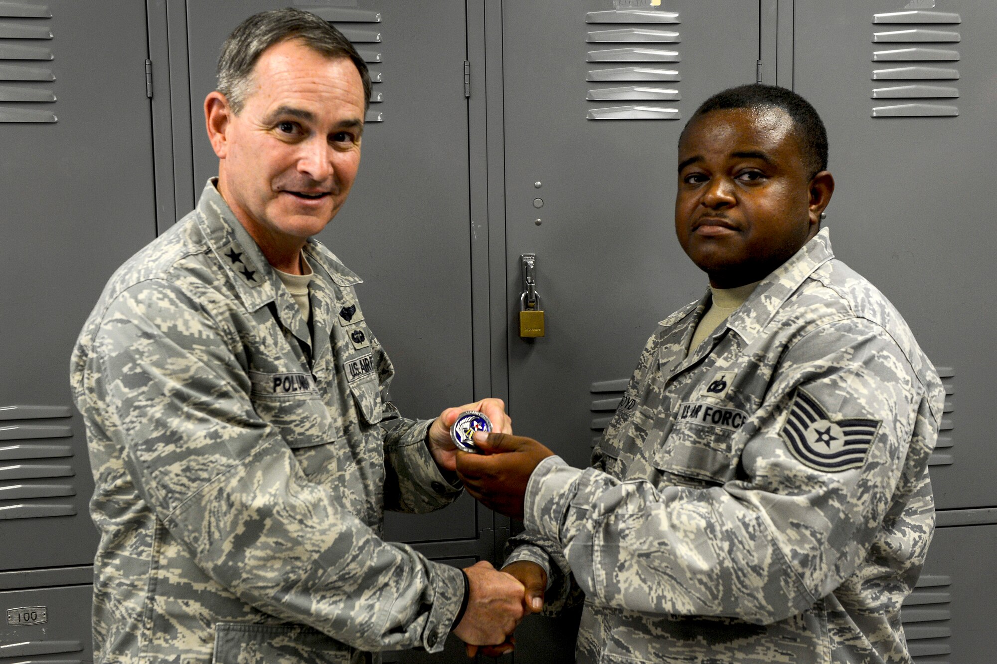 U.S. Air Force Maj. Gen. H. D. Polumbo Jr., Ninth Air Force commander, gives a Ninth Air Force commander’s coin to Tech. Sgt. Christopher Boyd, 20th Security Forces Squadron installation patrolman, at Shaw Air Force Base, S.C., July 28, 2015. Boyd received the coin for his leadership role while providing security for President Barack Obama.  (U.S. Air Force photo by Senior Airman Jensen Stidham/Released)