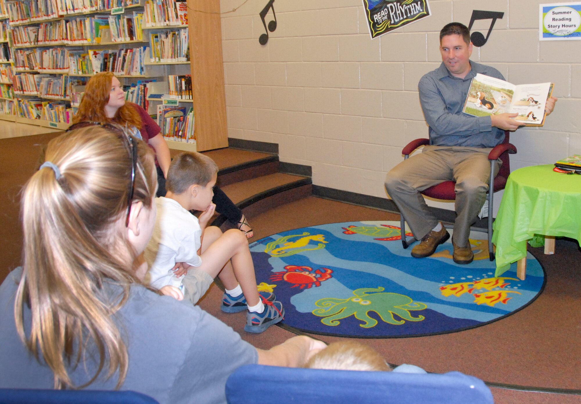 Jonathan Cansdale, Air Force Life Cycle Management Center member, volunteers to read to children during the Summer Reading Program. The program offers opportunities for children to sharpen their reading skills, learn about various music genres and associated dances, and participate in related art projects.  (U.S. Air Force photo/Kevin Gaddie)