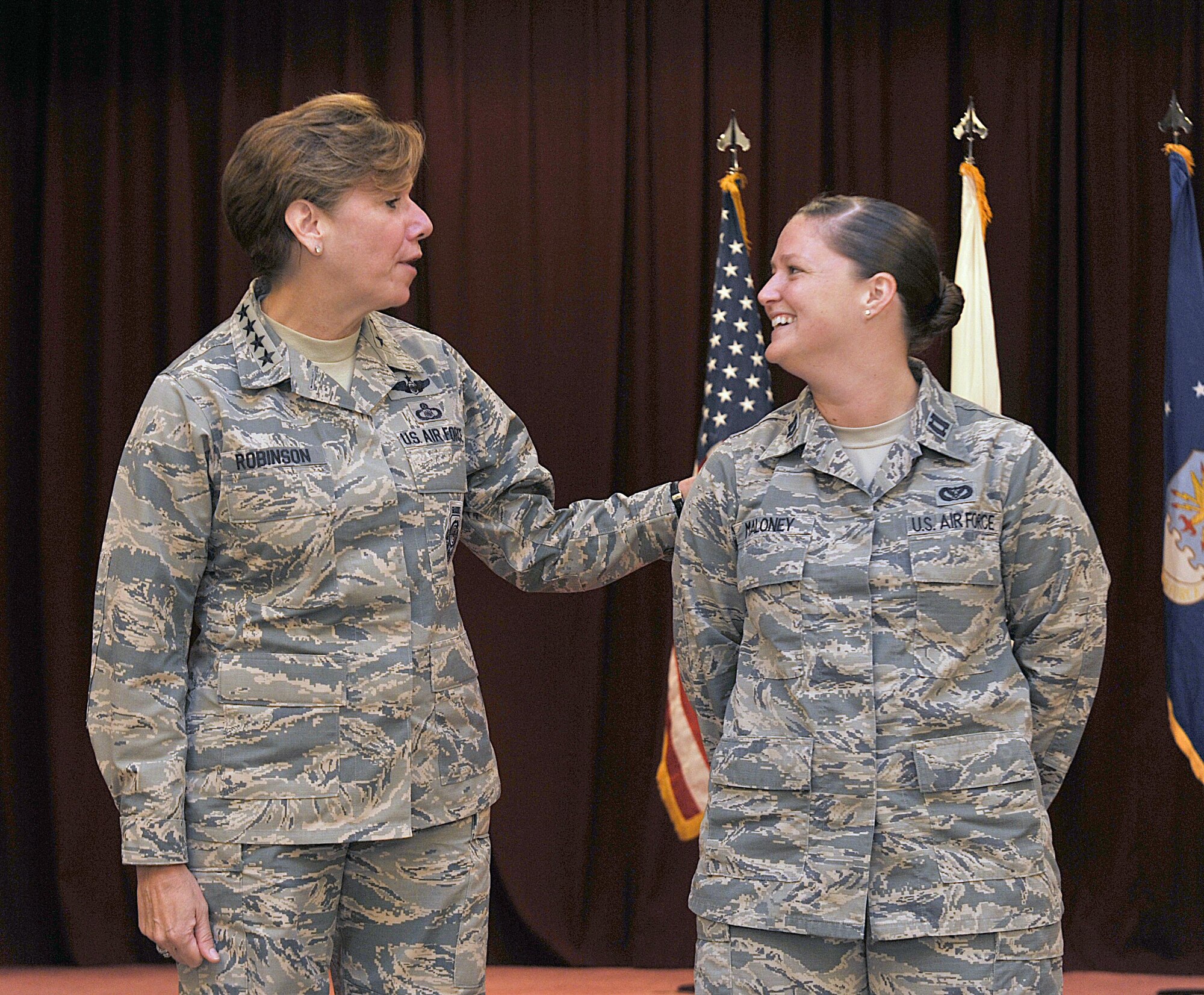 U.S. Air Force Gen. Lori J. Robinson, Pacific Air Forces commander, talks to U.S. Air Force Capt. Katrina Maloney, 718th Civil Engineer Squadron engineering flight deputy, after a coin presentation at the Kadena Officer’s Club on Kadena Air Base, Japan, Aug. 3, 2015. During her two-day visit, the general addressed several issues that are important to her, including Airmen taking care of Airmen and the strategic shift to the Pacific. She also communicated her expectations with Kadena leaders. (U.S. Air Force photo by Naoto Anazawa/Released)