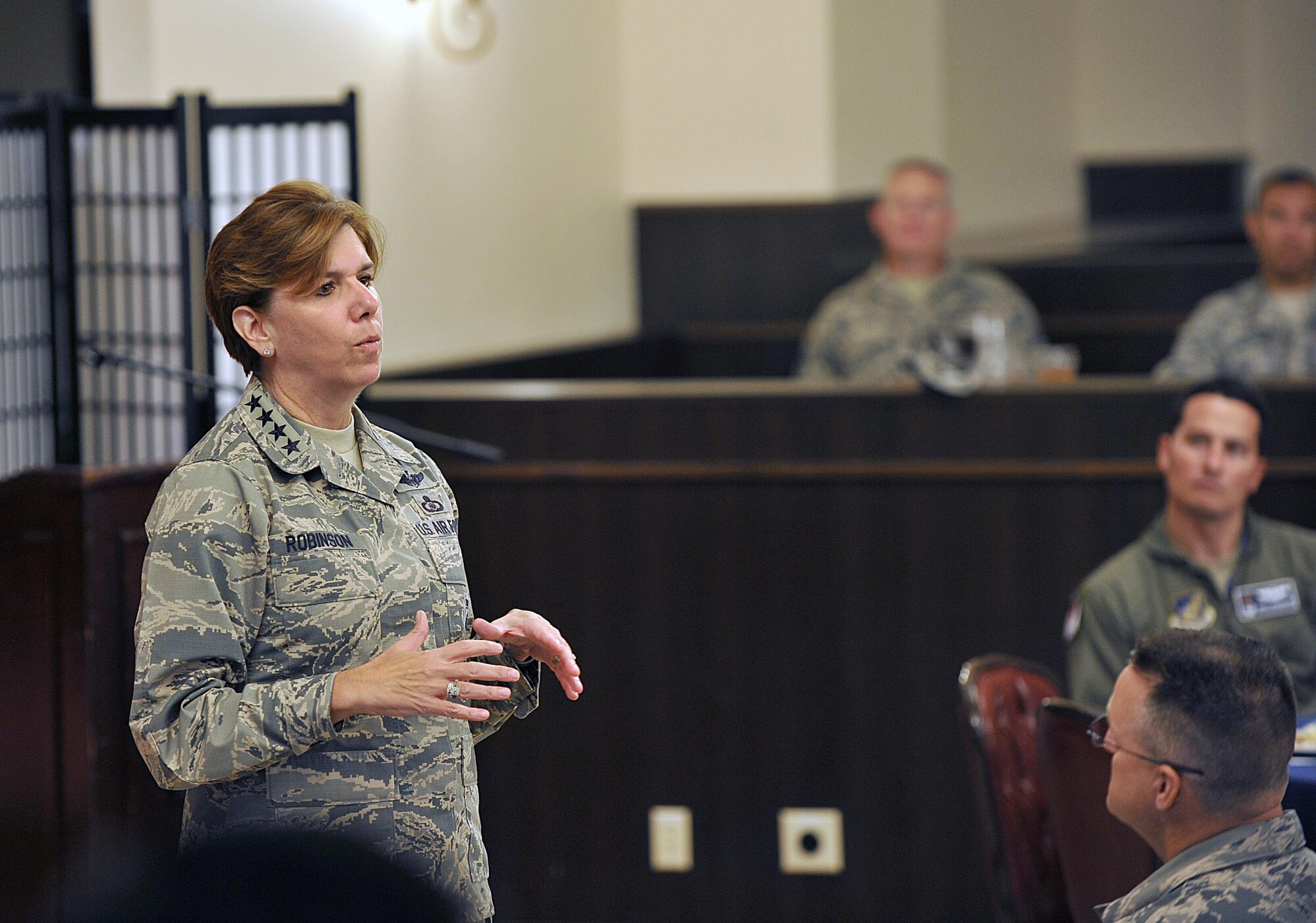 U.S. Air Force Gen. Lori J. Robinson, Pacific Air Forces commander, speaks to 18th Wing leaders and their spouses after a coin presentation at the Kadena Officer’s Club on Kadena Air Base, Japan, Aug. 3, 2015. During her two-day visit to the base, Robinson presented coins to several Airmen from Kadena in honor of their outstanding performance in their Air Force careers. (U.S. Air Force photo by Naoto Anazawa/Released)