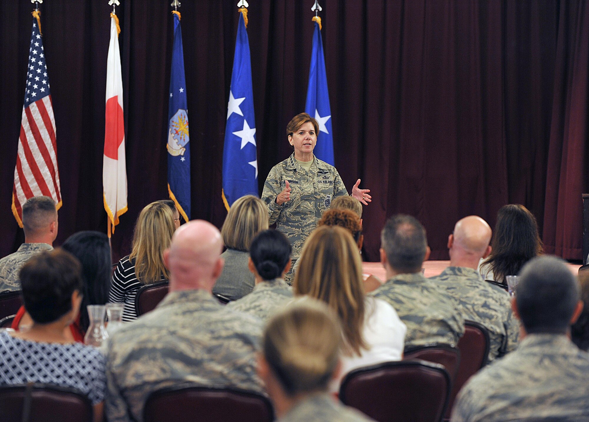 U.S. Air Force Gen. Lori J. Robinson, Pacific Air Forces commander, speaks to 18th Wing leaders and their spouses after a coin presentation at the Kadena Officer’s Club on Kadena Air Base, Japan, Aug. 3, 2015. During her two-day visit to the base, Robinson had a chance to talk to group commanders, superintendents and first sergeants to find out what challenges they face in their respective units. (U.S. Air Force photo by Naoto Anazawa/Released)