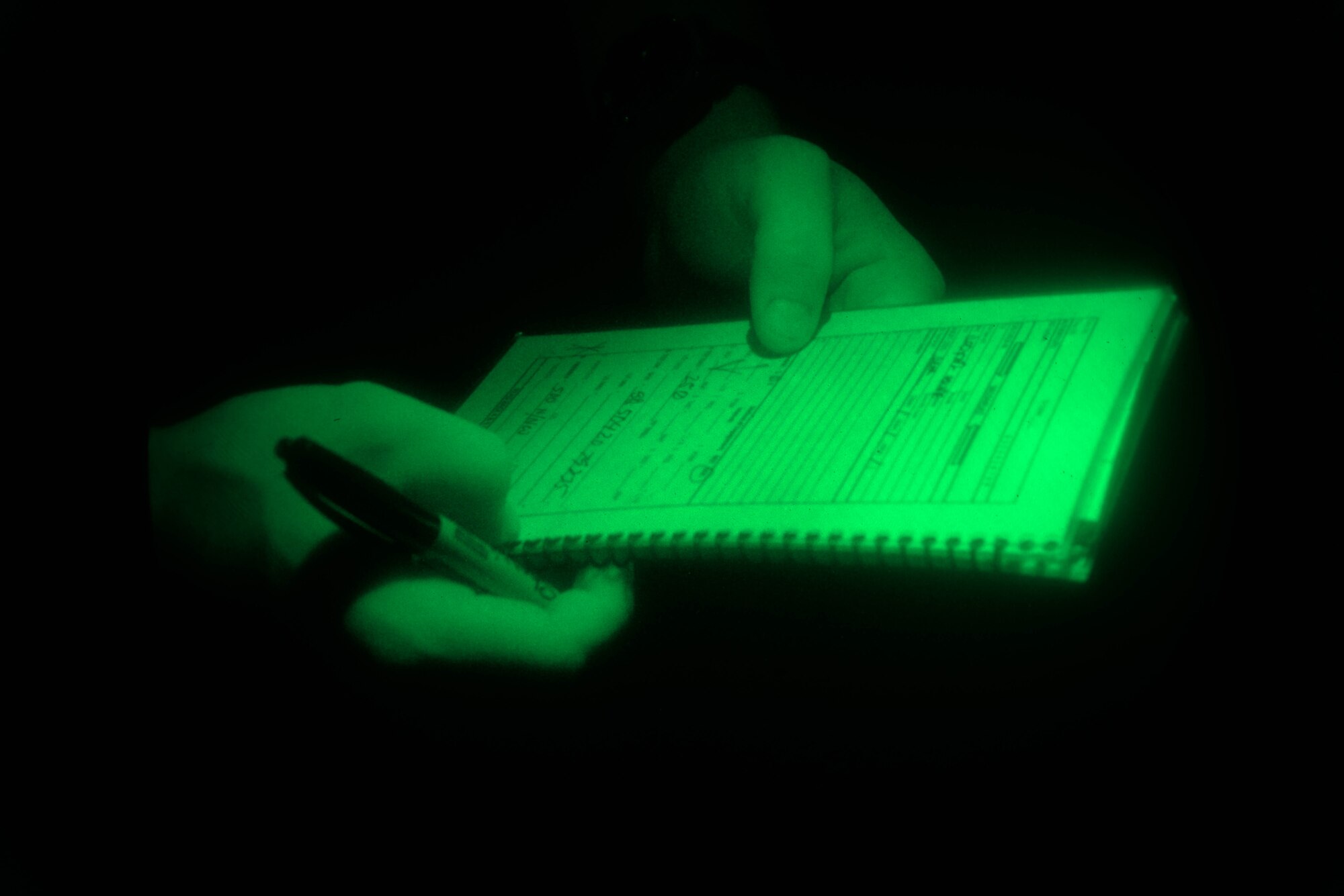 Senior Airman Ronald Page, 3rd Air Support Operations Squadron Tactical Air Control Party Airman, takes notes July 23, 2015, during a close air support exercise at Naval Ordnance Annex, Guam. During night training intervals, Page completed important qualifications training toward his certification as a joint terminal attack controller. (U.S. Air Force photo/Staff Sgt. Alexander W. Riedel/Released)