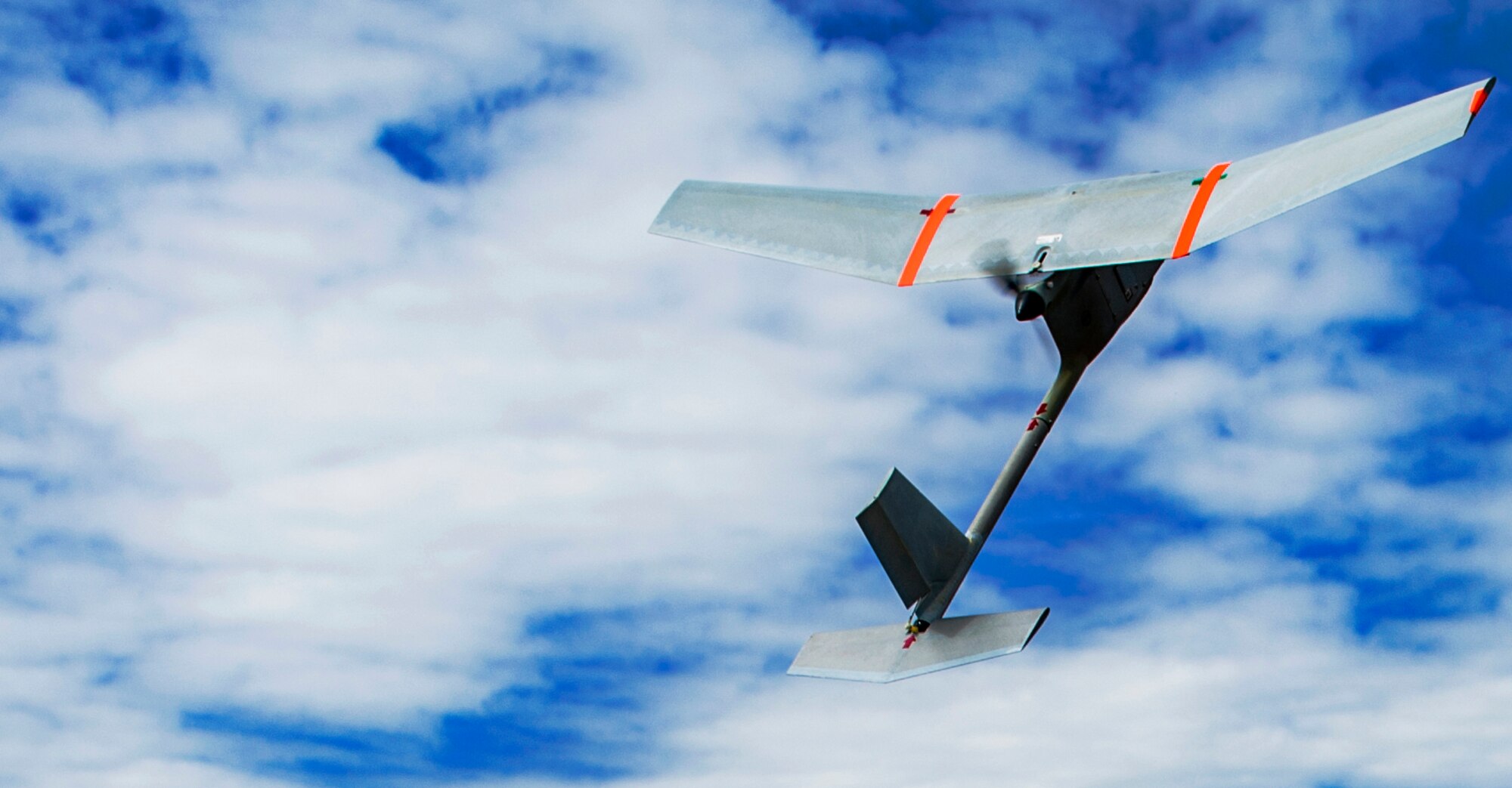 A Raven B small unmanned aerial system with a digital data link flies through the air during a SUAS proficiency and currency training at the airfield on U.S. Army Garrison Baumholder, Germany, July 23, 2015. The Raven B SUAS with DDL is used as an instrument of intelligence, surveillance and reconnaissance and used to defend military installations, fly over perimeters and assess battle damage. (U.S. Air Force photo by Airman 1st Class Timothy Kim/Released)