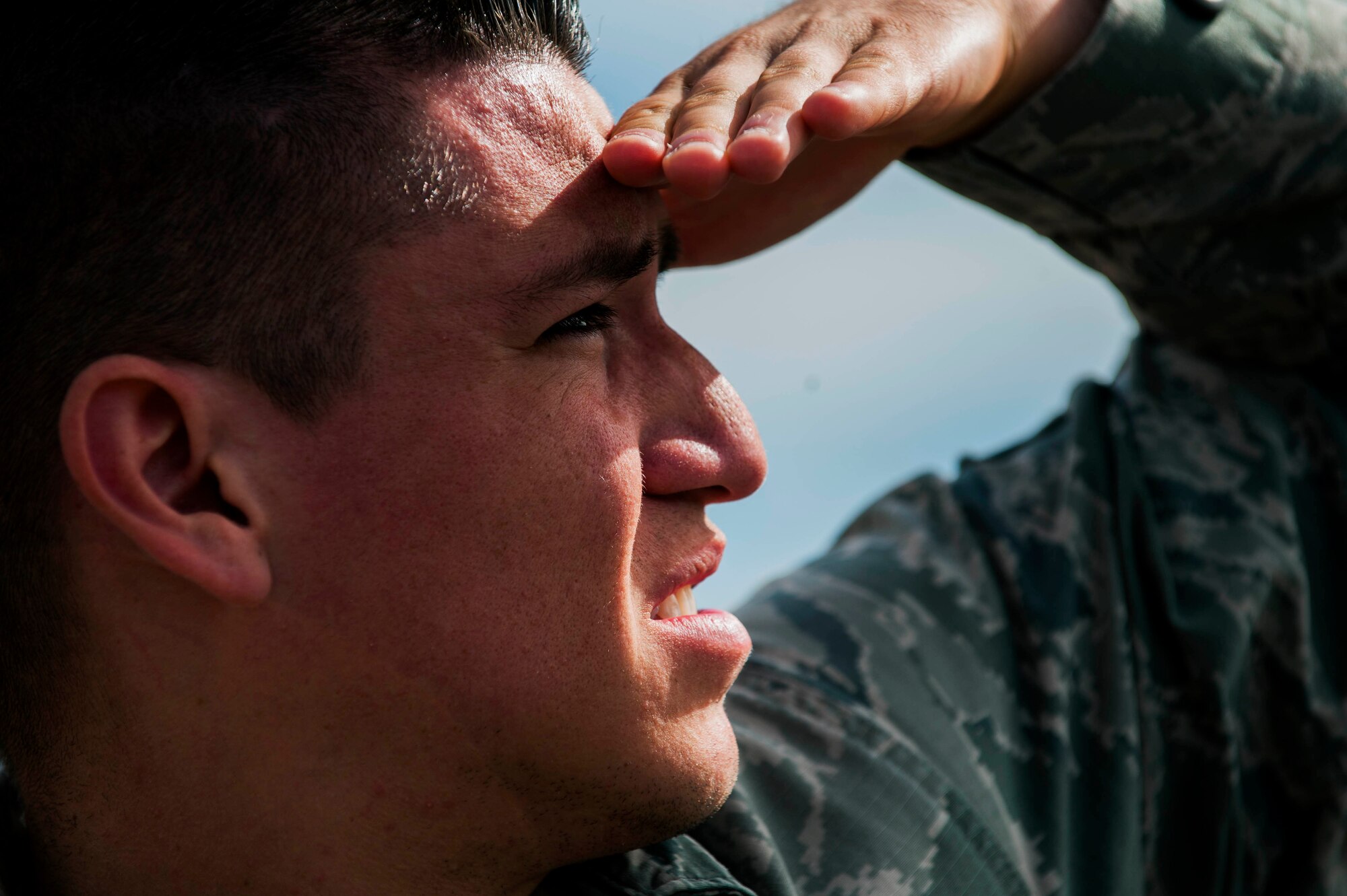 U.S. Air Force Senior Airman Alfonso Lopez, a 52nd Security Forces Squadron patrolman, searches the sky during a small unmanned aerial system proficiency and currency training at the airfield on U.S. Army Garrison Baumholder, Germany, July 23, 2015. Eighteen 52nd SFS members participated in a mandatory training session to ensure drone operators stay proficient and current in their ability to pilot the SUAS. (U.S. Air Force photo by Airman 1st Class Timothy Kim/Released)
