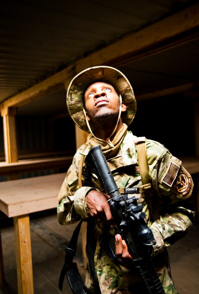 Staff Sgt. Andre McCoo, 919th Special Operations Security Forces Squadron, glances up at the sunlight coming from the ceiling after a room clearing drill during the squadron’s annual training at Camp Guernsey, Wyo., Aug. 3.  More than 20 Airmen went out West to help train two other Reserve security forces squadrons in ground combat and field training.  The 919th SOSFS Airmen lived in the makeshift camps and acted as opposing forces and local villagers interacting with the occupying security teams. (U.S. Air Force photo/Tech. Sgt. Sam King)