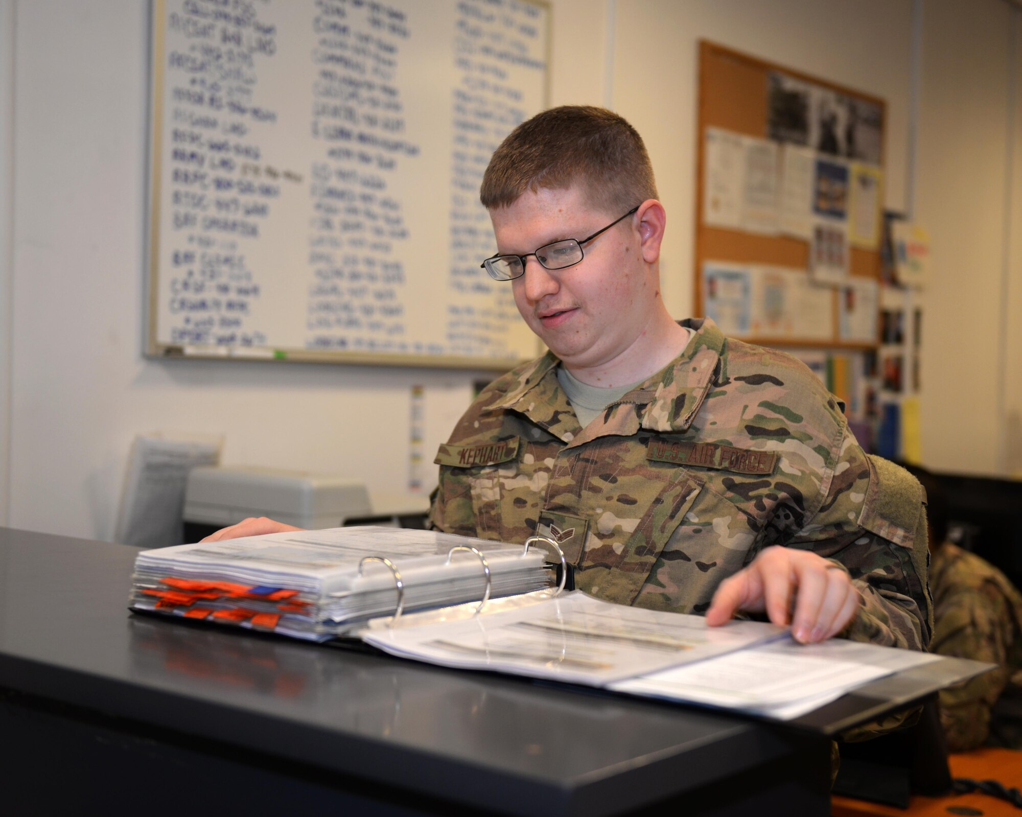 U.S. Air Force Senior Airman Tyler Kephart, 455th Expeditionary Force Support Squadron Personnel Support for Contingency Operations deliberate crisis action planning executions segments operator, looks through PERSCO records Aug. 3, 2015, at Bagram Airfield, Afghanistan. The PERSCO team is responsible for keeping accountability for all Air Force personnel at BAF and surrounding FOBs in the AOR. (U.S. Air Force photo by Senior Airman Cierra Presentado/Released)