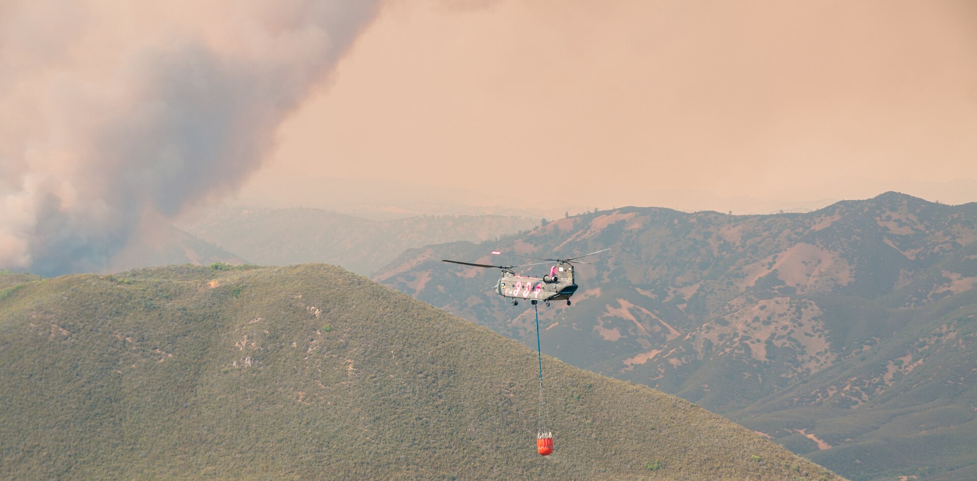 A CH-47 Chinook helicopter from the 1-126th Aviation Regiment prepares to approach for a water drop during the Rocky Fire near Clearlake, California, Aug. , 2015.
