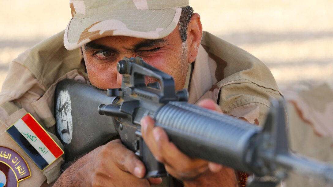 An Iraqi army soldier aims down the sight of an M16 rifle during marksmanship fundamentals training led by Danish service members at Al Asad Air Base, Iraq, July 27, 2015. Through the advise and assist and building partner capacity missions, Combined Joint Task Force — Operation Inherent Resolve’s multinational coalition has trained approximately 11,000 Iraqi security force personnel to defeat the Islamic State of Iraq and the Levant and restore the sovereignty and security of Iraq.