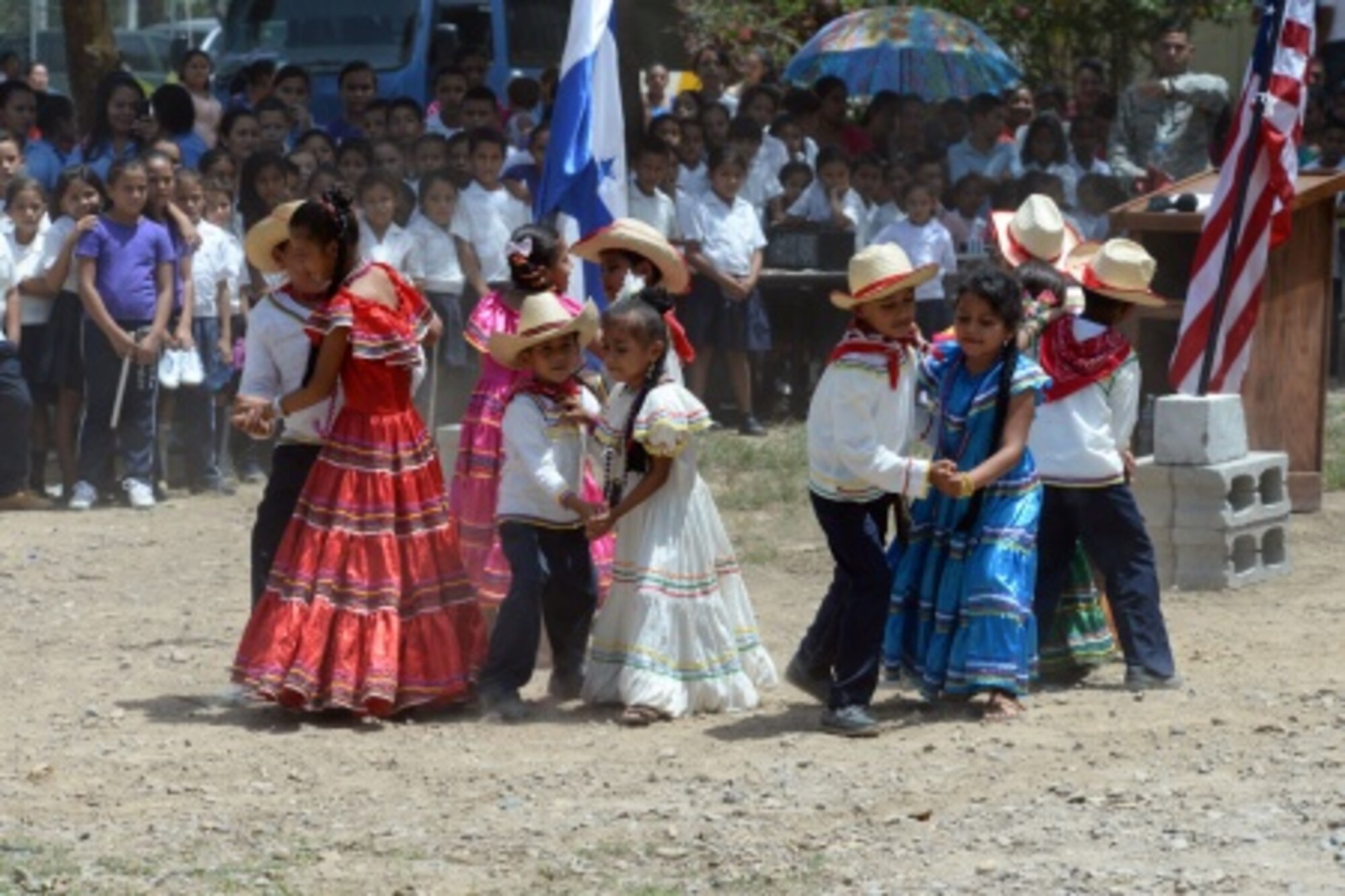 Gabriela Mistral students perform a traditional dance during the ribbon-cutting ceremony at the Gabriela Mistral school in Ocotes Alto, Honduras, July 28, 2015. The ribbon-cutting ceremony celebrated the opening of the new two-classroom schoolhouse. The schoolhouse was one of the key projects that occurred as part of the New Horizons Honduras 2015 training exercise taking place in and around Trujillo, Honduras. 
 New Horizons was launched in the 1980s and is an annual joint humanitarian assistance exercise that U.S. Southern Command conducts with a partner nation in Central America, South America or the Caribbean. The exercise improves joint training readiness of U.S. and partner nation civil engineers, medical professionals and support personnel through humanitarian assistance activities. (U.S. Air Force photo by Capt. David J. Murphy/Released)
