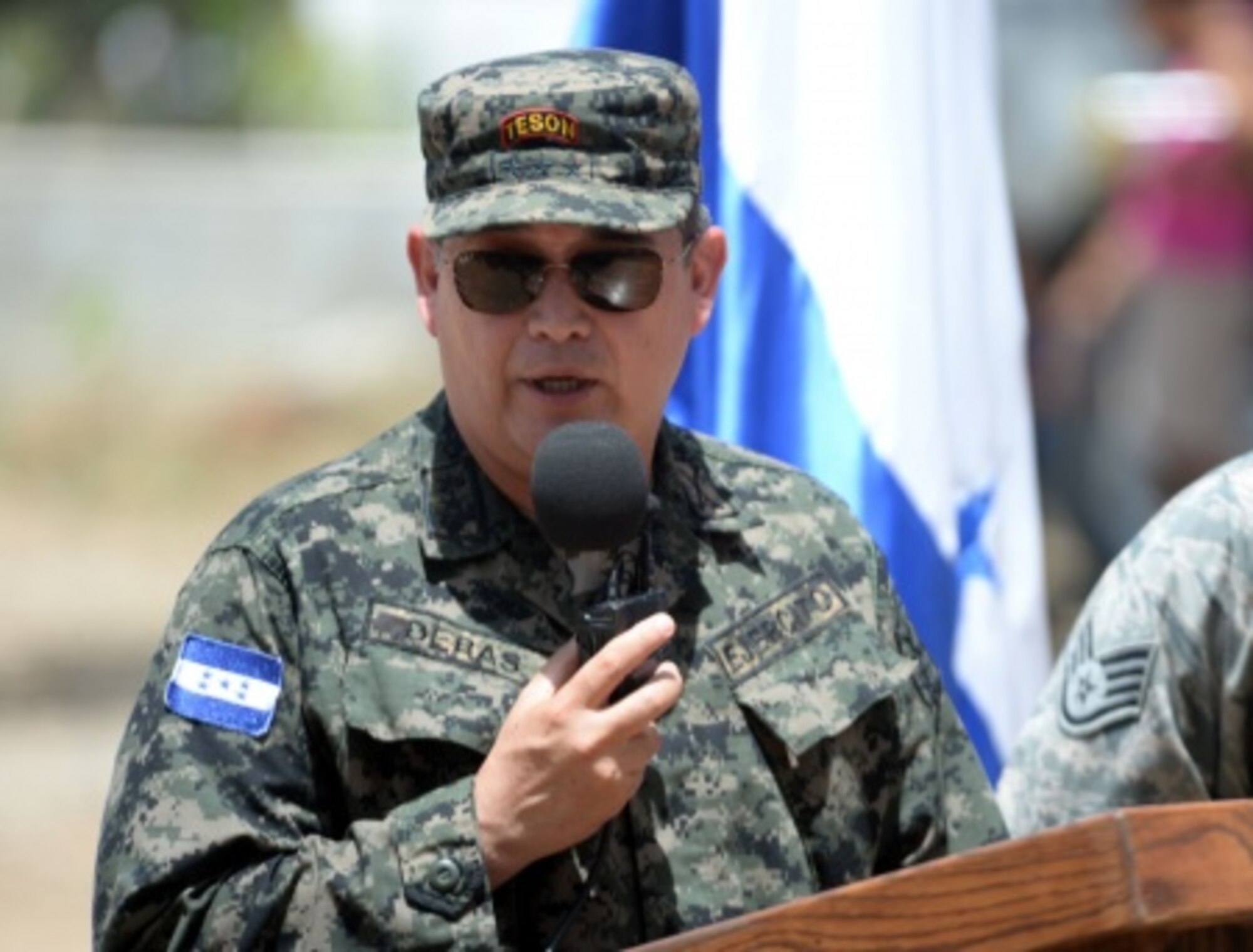 Col. Rafael Deras, 15th Honduran Army’s Battalion commander speaks at the ribbon-cutting ceremony for the new two-classroom schoolhouse at the Gabriela Mistral school in Ocotes Alto, Honduras, July 28, 2015. The event marked the official opening of the building which was one of the key projects as part of the New Horizons Honduras 2015 training exercise taking place in and around Trujillo, Honduras. New Horizons was launched in the 1980s and is an annual joint humanitarian assistance exercise that U.S. Southern Command conducts with a partner nation in Central America, South America or the Caribbean. The exercise improves joint training readiness of U.S. and partner nation civil engineers, medical professionals and support personnel through humanitarian assistance activities. (U.S. Air Force photo by Capt. David J. Murphy/Released)
