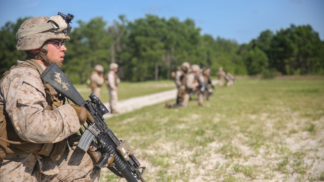 Lance Cpl. Joe Escobedo, a rifleman with Golf Company, 2nd Battalion, 2nd Marine Regiment, looks toward a target after conducting a squad attack at Marine Corps Base Camp Lejeune, North Carolina, July 28. The training incorporated multiple weapon systems, including the M16A4 service rifle, M203 grenade launcher, Shoulder-launched Multipurpose Assault Weapon and M249 Squad Automatic Weapon to help increase interoperability between weapons in training operations.