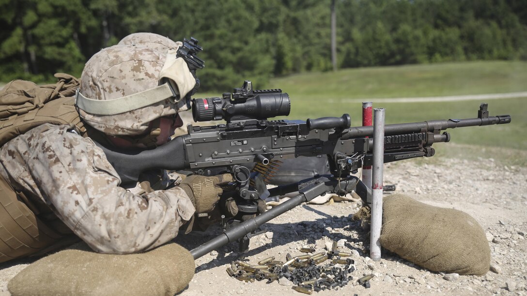Pfc. Dan Papa, a machine gunner with Golf Company, 2nd Battalion, 2nd Marine Regiment, provides suppressing fire with an M249 Squad Automatic Weapon during a squad attack at Marine Corps Base Camp Lejeune, North Carolina, July 28. A squad of Marines maneuvered toward a target while two machine gunners provided fire to help clear the battlefield.