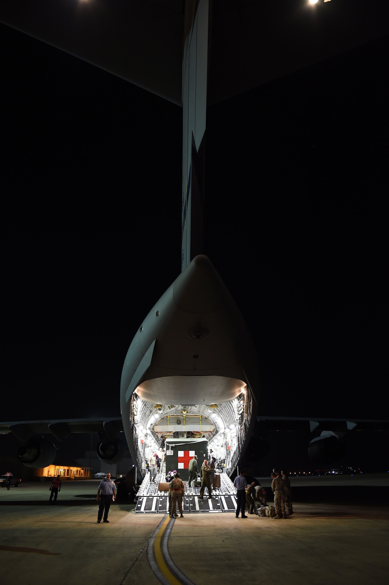 Members of the 559th En-Route Patient Staging System work with air crew from the 172nd Airlift Wing, a C-17 Air National Guard unit from Mississippi, to prepare wounded warriors for transport July 23, 2015, at nearby Kelly Air Field. (U.S. Air Force photo/Staff Sgt. Jerilyn Quintanilla)
