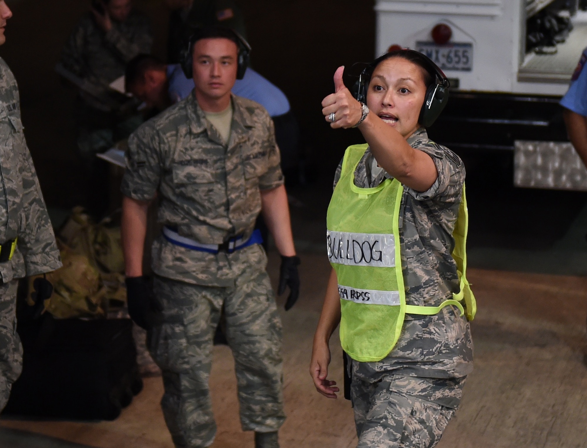 Tech. Sgt. Crystal Beckham, 559th En-Route Patient Staging System flight chief, gives the signal for wounded warriors to start being moved off a C-17 Globemaster III from Mississippi’s 172nd Airlift Wing July 23, 2015, at nearby Kelly Air Field. (U.S. Air Force photo/Staff Sgt. Jerilyn Quintanilla) 
