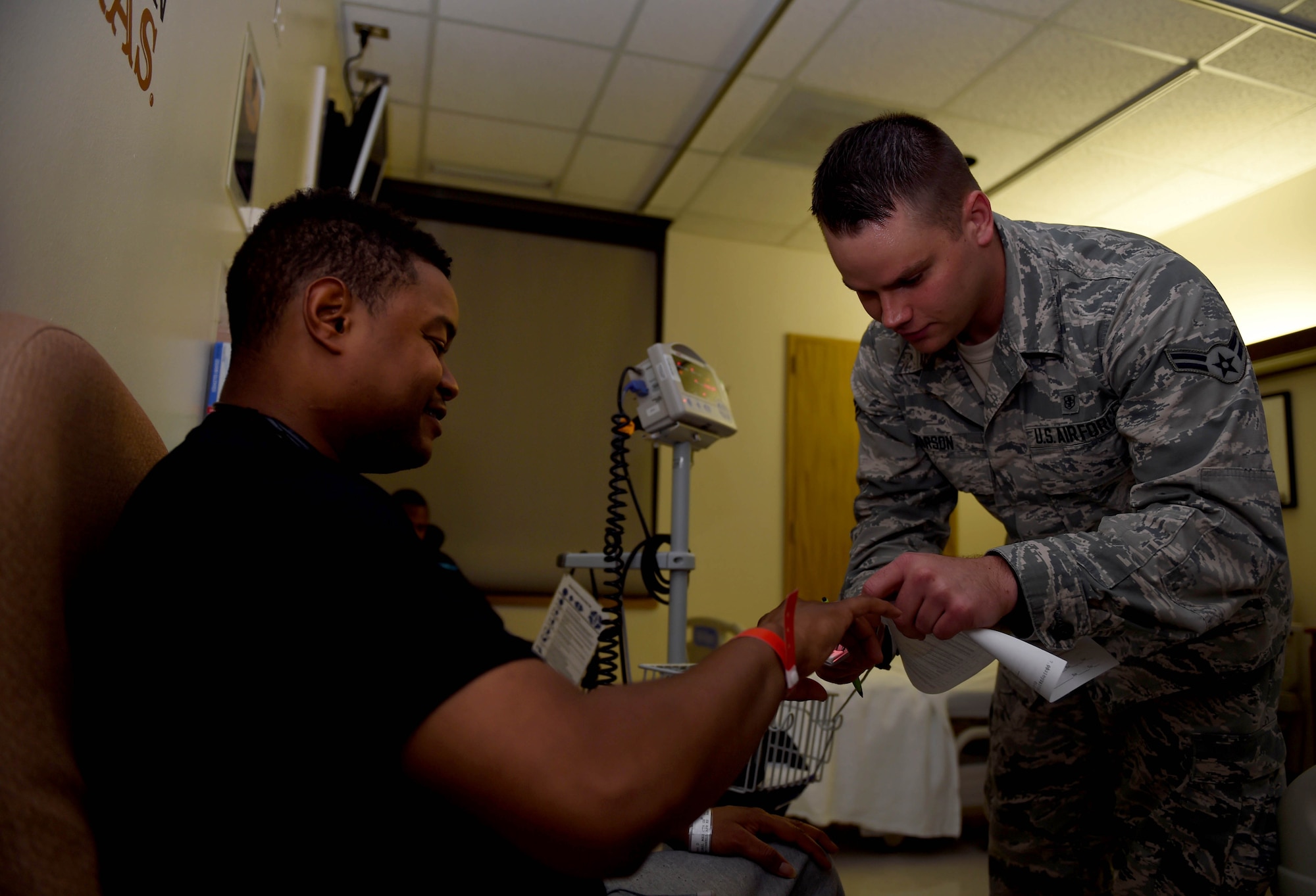 Airman 1st Class Zack Tarson checks a patient’s vitals after arriving to the 559th En-Route Patient Staging System facility July 23, 2015, at the Wilford Hall Ambulatory Surgical Center, Joint Base San Antonio-Lackland. (U.S. Air Force photo/Staff Sgt. Jerilyn Quintanilla)
