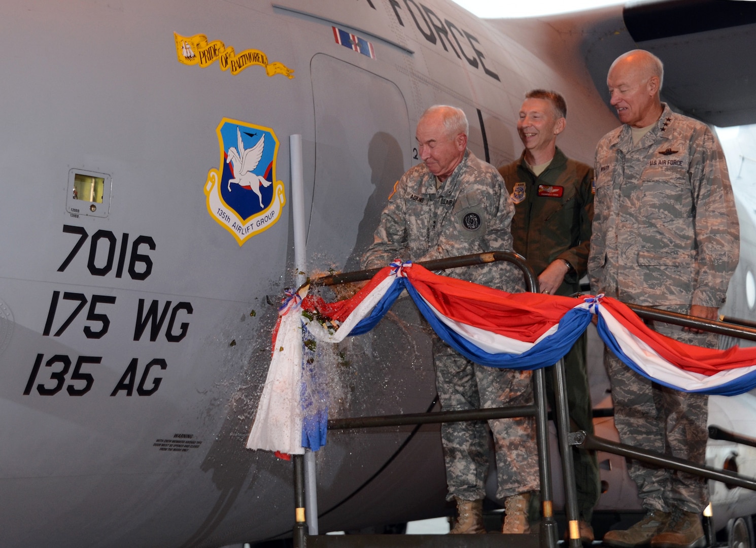 Army Maj. Gen. James A. Adkins, adjutant general of the Maryland National Guard, christens the new C-27J Spartan during an arrival ceremony August 13, 2011, at Warfield Air National Guard Base, Baltimore, MD while Air Force Col. Thomas E. Hans, commander 135th Airlift Group and Air Force Lt. Gen. Harry Wyatt, director of the Air National Guard, watch on. The 135th Airlift Group transitioned from the C-130J Hercules to the C-27J Spartan, which was designed to meet Air Force requirements for a rugged, medium-sized air-land transport.
