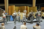 Air National Guard band members assigned to the 571st Air Force band, Missouri National Guard, perform an acoustic version of a popular song while deployed to Southwest Asia in early August 2011. The band, Sidewinder, is a 10-member band that quickly gained fame after the a video of the performance was uploaded to YouTube.