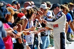 Dale Earnhardt Jr., driver of the No. 88 National Guard NASCAR racecar, signs autographs and greets the fans before race day at Michigan International Speedway in Brooklyn, Mich., Sunday Aug. 21, 2011. Earnhardt and the No. 88 National Guard crew sit in ninth place in the Sprint Cup championship standings with only three races left before the chase for the cup.