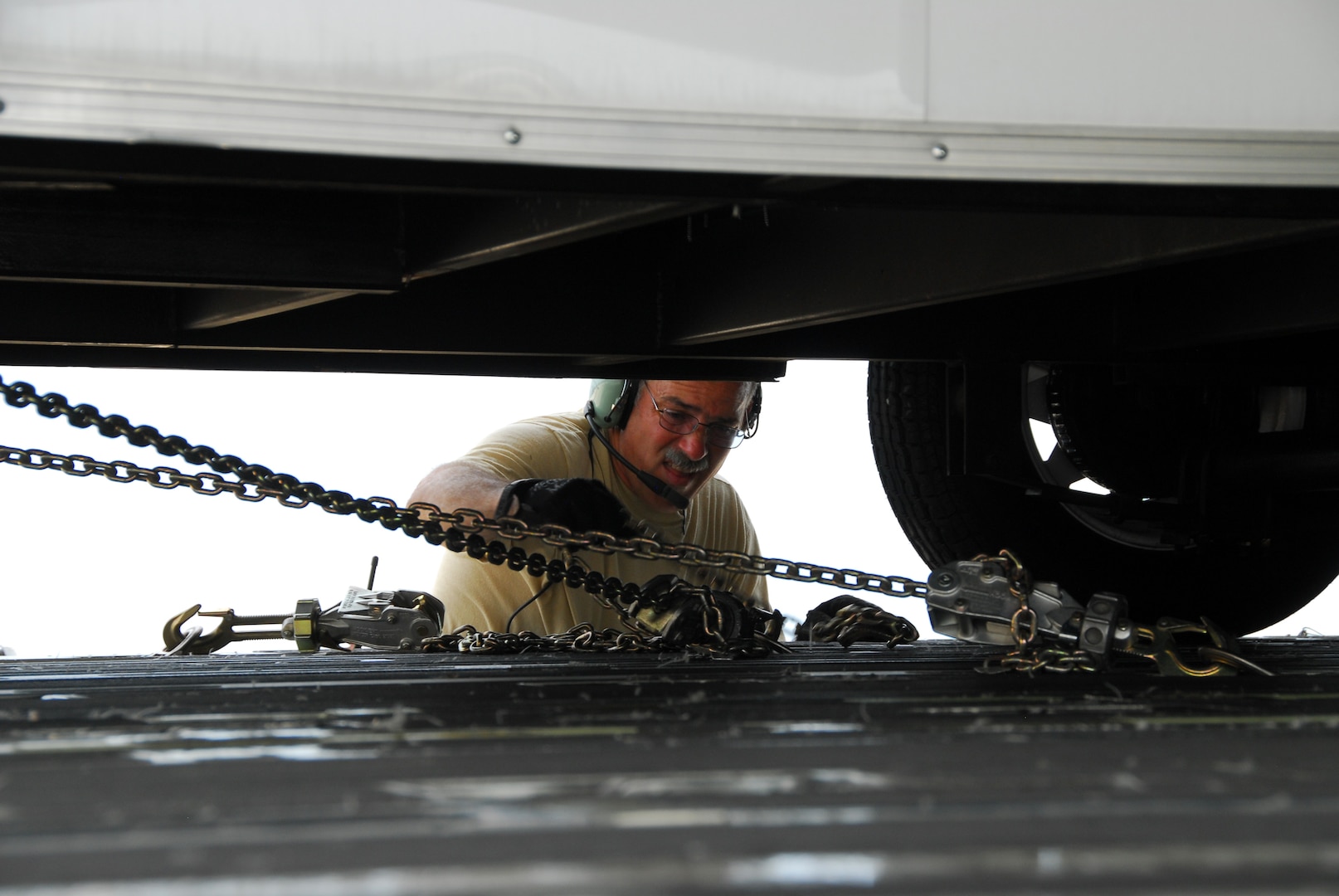 Air Force Tech. Sgt. Bart Panighetti, an air cargo specialist from the 146th
Airlift Wing, California Air National Guard, detaches a trailer loaded on a
C-17 Globemaster III military transport aircraft in Volk Field, Wis., July 9,
2011, for Patriot Exercise 2011. The C-17 had just transported a Chemical,
Biological, Radiological, Nuclear and high-yield Explosive Enhanced Response
Force Package from California to Wisconsin. The 9th CERFP, of the California
National Guard, was the first team transported entirely by military aircraft
as part of Patriot, an international large-scale emergency response training
exercise.
