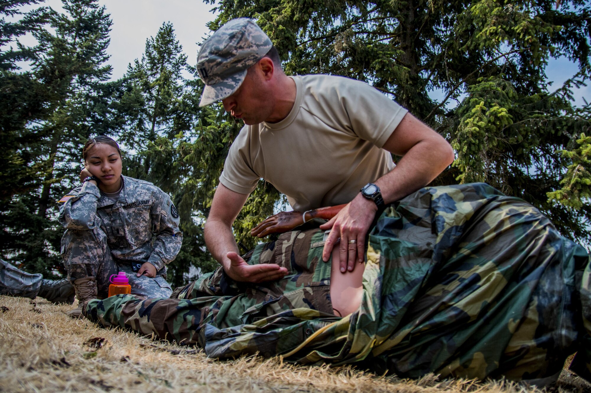 Captain Ryan Garabrandt, 446th Aeromedical Staging Squadron nurse, checks for spinal injuries on a training manikin in preparation for the annual Expert Field Medical Badge test at McChord Field, Wash., Aug. 2, 2015. The Expert Field Medical Badge is a unique distinction worn only by the most battle-ready and elite medical personnel in the military. Every year at Joint Base Lewis-McChord, Wash., a two-week intensive testing event is set up to qualify eligible service members from around the country for the right to wear the coveted badge. (U.S. Air Force photo by Senior Airman Daniel Liddicoet)
