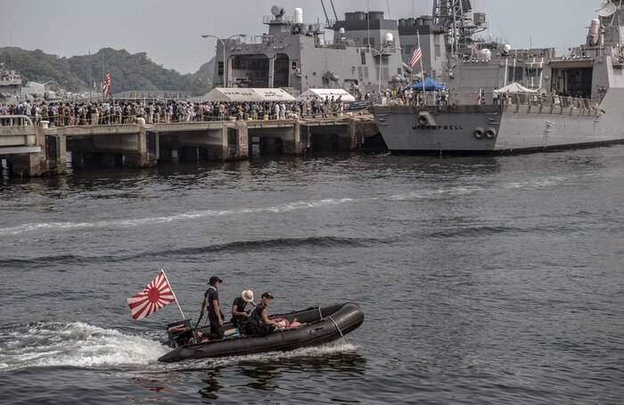 YOKOSUKA, Japan (Aug. 1, 2015) - A Japan Maritime Self-Defense Force (JMSDF) small boat passes near the Arleigh Burke-class guided-missile destroyer USS McCampbell (DDG 85) as thousands of visitors tour the ship at the JMSDF Yokosuka naval base during the 39th annual Friendship Day.  The open-base event encourages interaction and strengthens bonds between our two nations.  