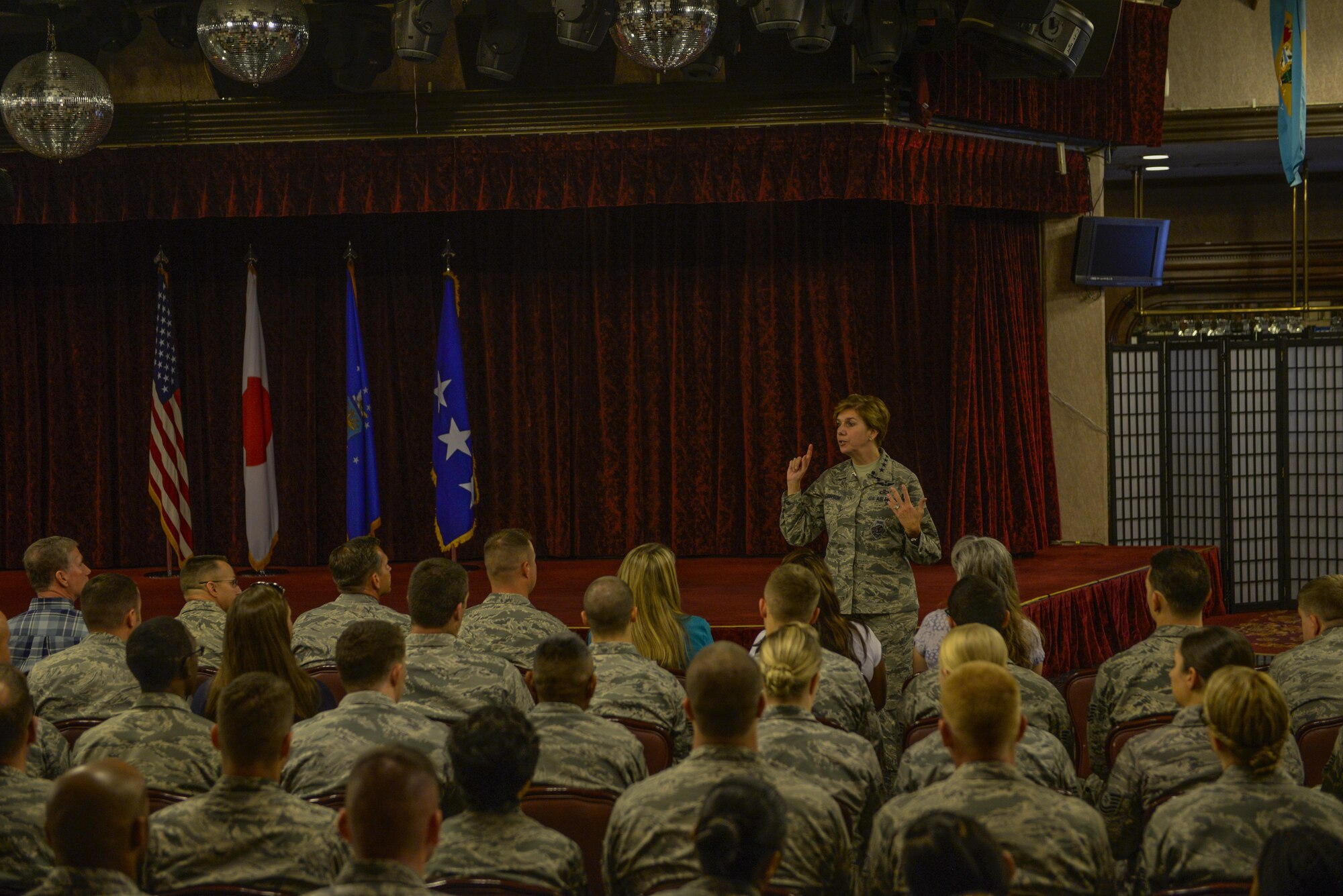 U.S. Air Force Gen. Lori Robinson, Pacific Air Forces commander, answers questions from Airmen during an all-call at Kadena Air Base, Japan, Aug. 4, 2015. Kadena is only one stop for Robinson as she visits U.S. Air Force bases within the command before returning to Joint Base Pearl Harbor-Hickam, Hawaii. (U.S. Air Force photo by Senior Airman Stephen G. Eigel/Released)