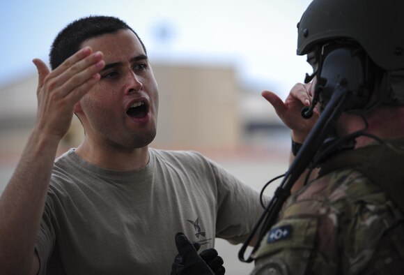 Tech. Sgt. Robert Laxton, 1st Special Operations Air Operations Squadron NCO-in-charge of wing theater planning, acts as a member of opposition forces who is simulating an attempt to gain access to an aircraft during a task force exercise on the flight line at Hurlburt Field, Fla., July 24, 2015. Exercise scenarios included downed aircraft site security and armed escort. Through the scenarios, DAGRE was able to accomplish multiple training objectives including close quarters combat, small unit tactics, flight deck denial, fly away security, close air support, casualty evacuation and more. (U.S. Air Force photo by Senior Airman Meagan Schutter)