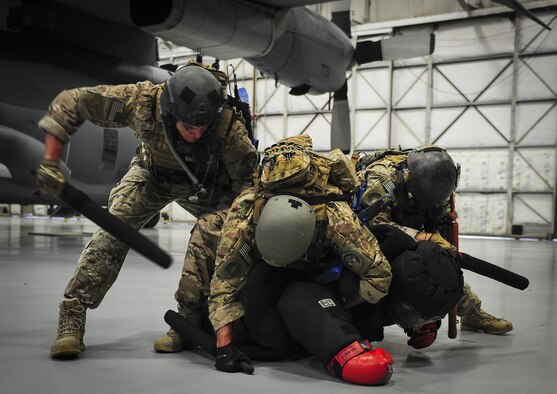 Airmen with the 1st Special Operations Security Forces Squadron deployed aircraft ground response element take down a member of opposition forces who simulated an attempt to gain access to an aircraft during a task force exercise on Hurlburt Field, Fla., July 24, 2015. Exercise scenarios included downed aircraft site security and armed escort. Through the scenarios, DAGRE was able to accomplish multiple training objectives including close quarters combat, small unit tactics, flight deck denial, fly away security, close air support, casualty evacuation and more. (U.S. Air Force photo by Senior Airman Meagan Schutter)