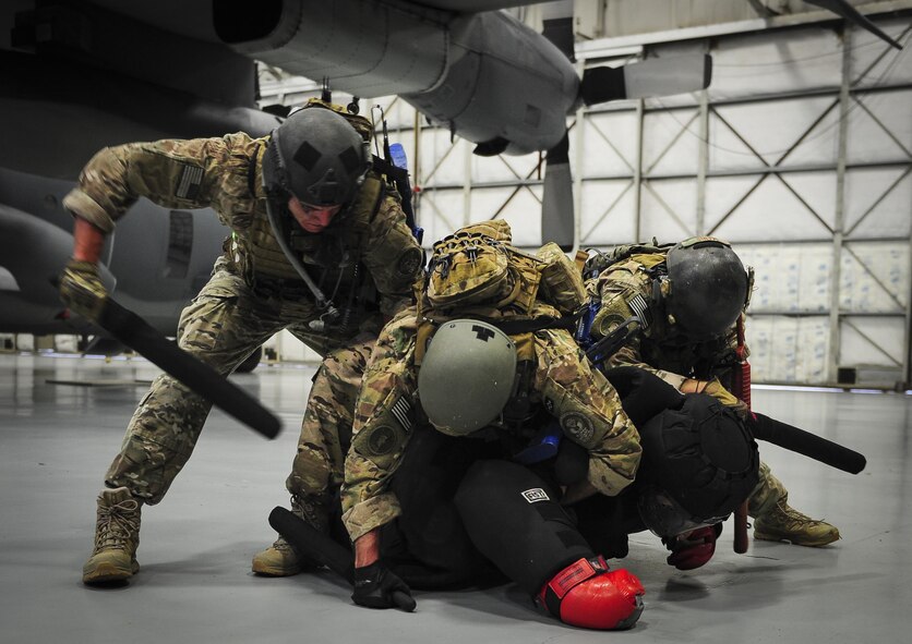 Airmen with the 1st Special Operations Security Forces Squadron deployed aircraft ground response element take down a member of opposition forces who simulated an attempt to gain access to an aircraft during a task force exercise on Hurlburt Field, Fla., July 24, 2015. Exercise scenarios included downed aircraft site security and armed escort. Through the scenarios, DAGRE was able to accomplish multiple training objectives including close quarters combat, small unit tactics, flight deck denial, fly away security, close air support, casual evacuation and more. (U.S. Air Force photo by Senior Airman Meagan Schutter)