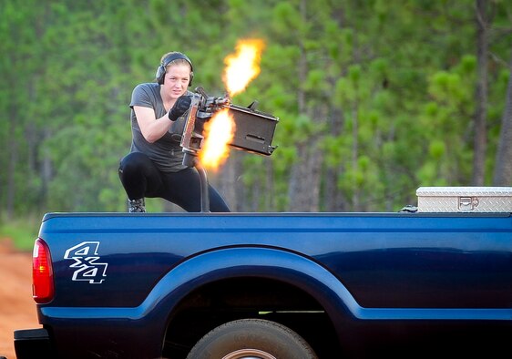 Senior Airman Rose Merotta, opposition forces augmentee, operates an m240 machine gun during a task force exercise at Hurlburt Field, Fla., July 27, 2015. Exercise scenarios included downed aircraft site security and armed escort. Through the scenarios, the 1st Special Operations Security Forces Squadron deployed aircraft ground response element was able to accomplish multiple training objectives including close quarters combat, small unit tactics, flight deck denial, fly away security, close air support, casualty evacuation and more. (U.S. Air Force photo by Senior Airman Meagan Schutter)