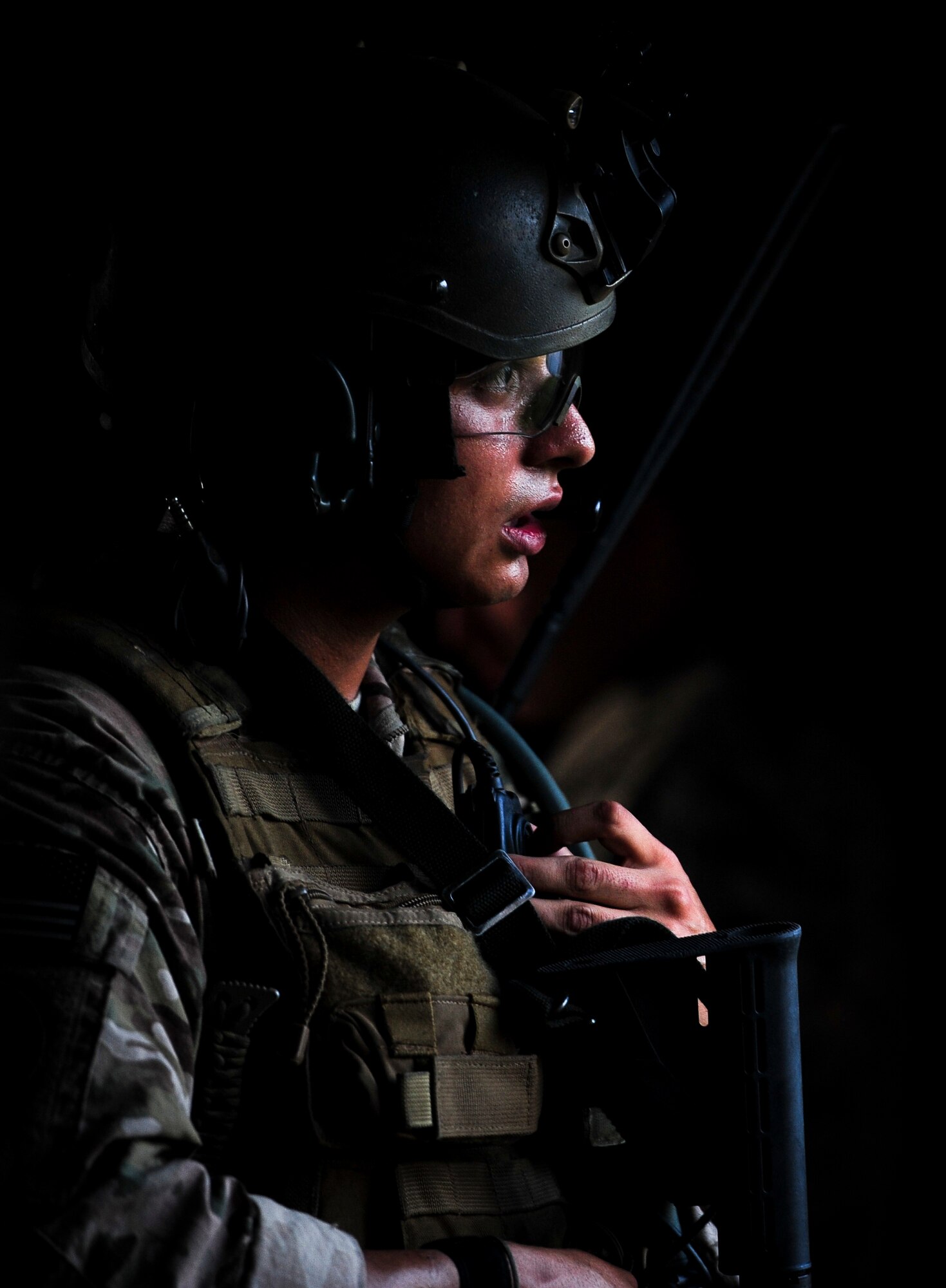 Senior Airman Ricardo Maggin, 1st Special Operations Security Forces Squadron deployed aircraft ground response element team member, communicates with his team during a task force exercise on Eglin Range Complex, Fla., July 27, 2015. Exercise scenarios included downed aircraft site security and armed escort. Through the scenarios, DAGRE was able to accomplish multiple training objectives including close quarters combat, small unit tactics, flight deck denial, fly away security, close air support, casual evacuation and more. (U.S. Air Force photo by Senior Airman Meagan Schutter)